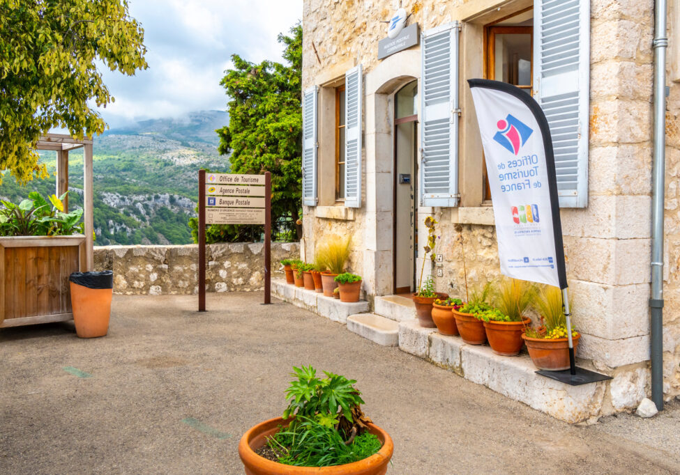View of the tourism office, post office and bank in the medieval walled village of Gourdon, in the Alpes-Maritimes region of France on September 21 2019.