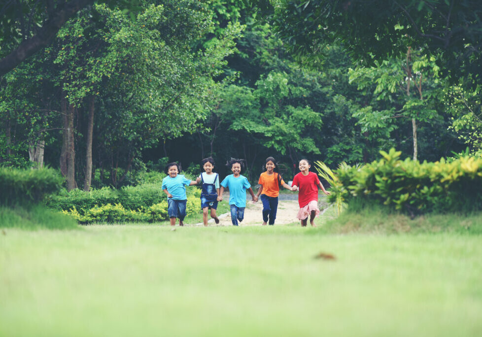 Group Of Young Children Running and playing in the park